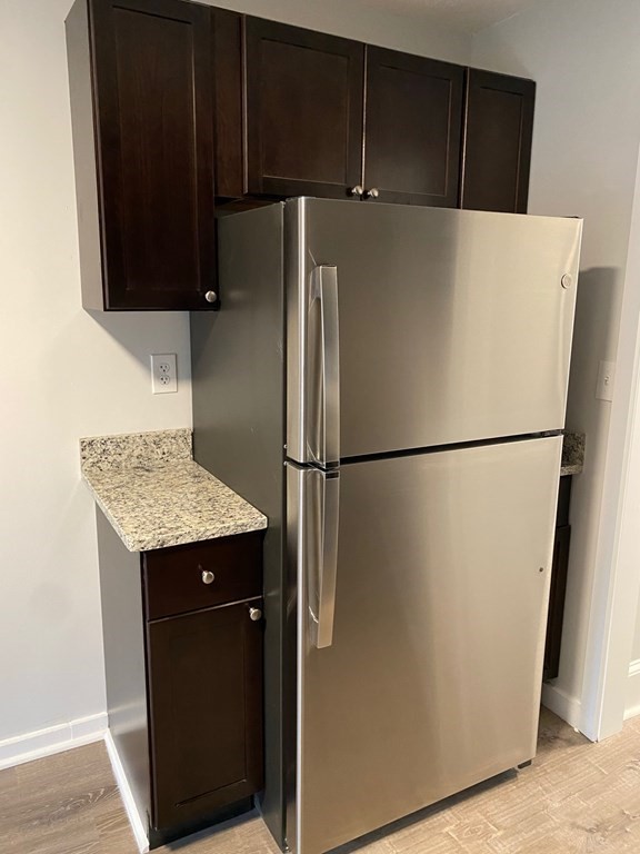 200 Congress Avenue, Unit 3 Chelsea, MA 02150 - Photo 6 of 14 a utility room with wooden floor and cabinets