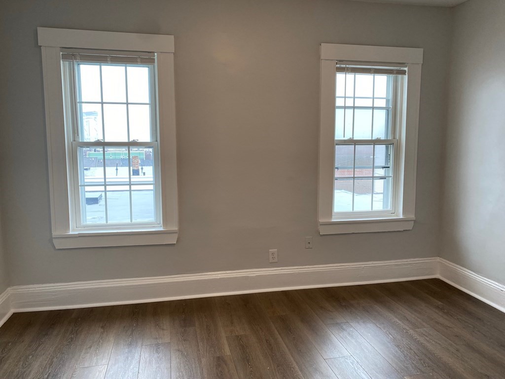 200 Congress Avenue, Unit 3 Chelsea, MA 02150 - Photo 8 of 14 an empty room with wooden floor and windows
