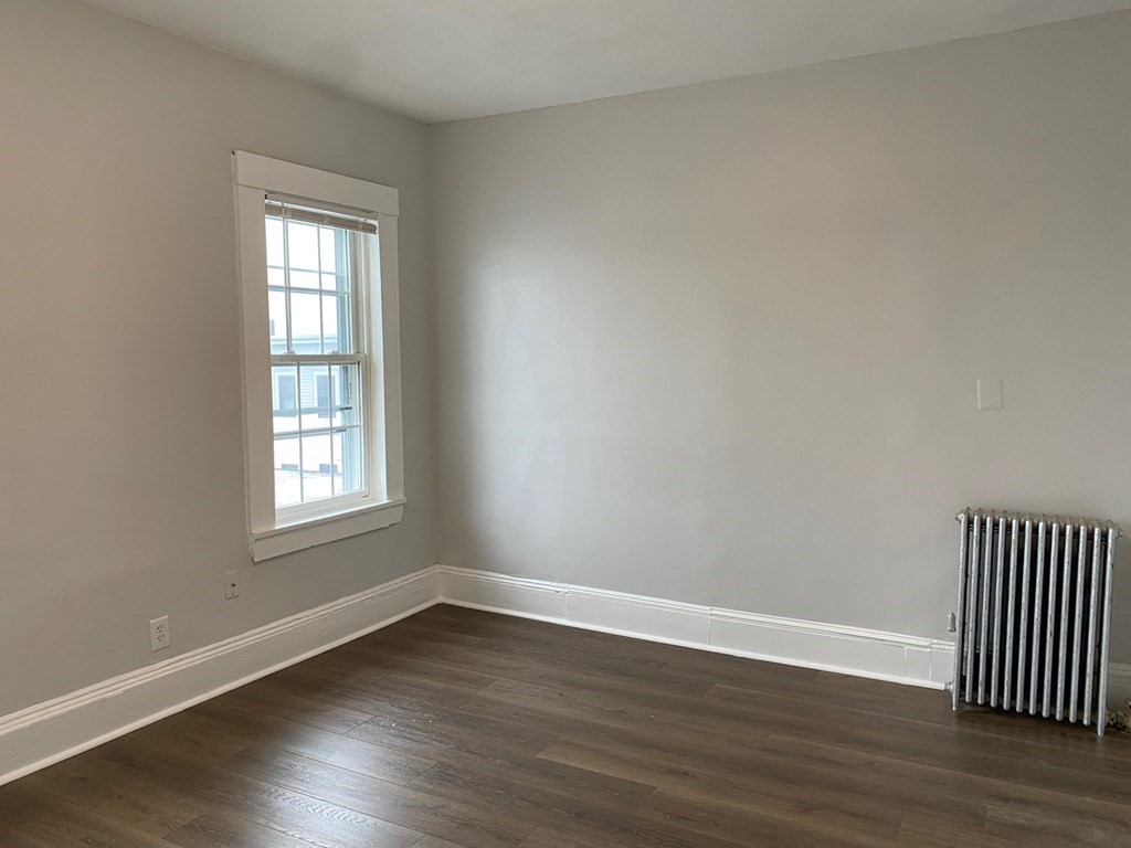 200 Congress Avenue, Unit 3 Chelsea, MA 02150 - Photo 9 of 14 a view of an empty room with wooden floor and a window