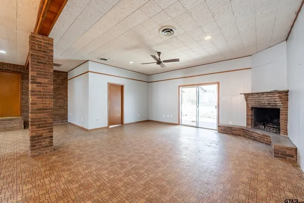 a view of a livingroom with wooden floor and a ceiling fan
