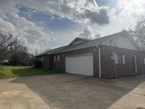 a backyard of a house with yard and garage