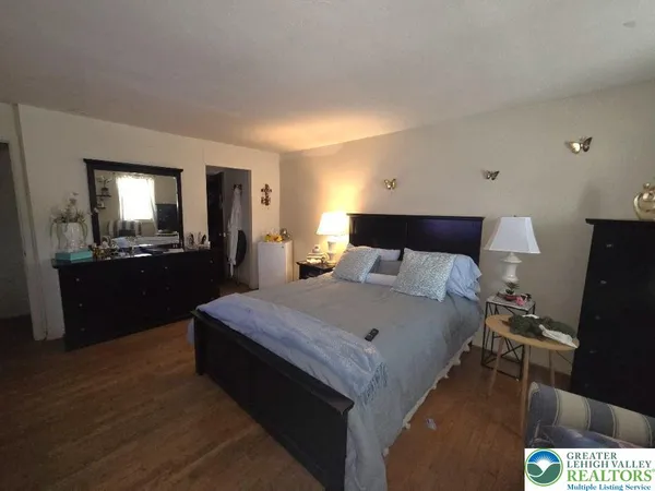a bedroom with a bed and a dresser