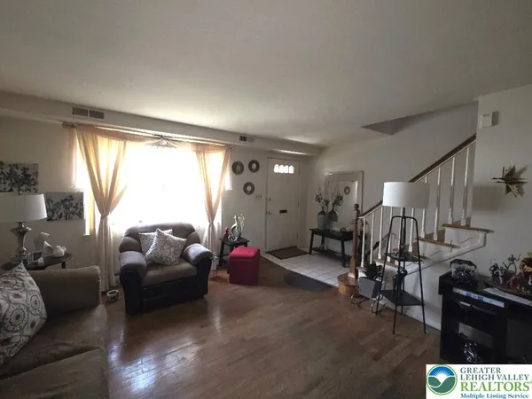a living room with furniture a window and gym equipment