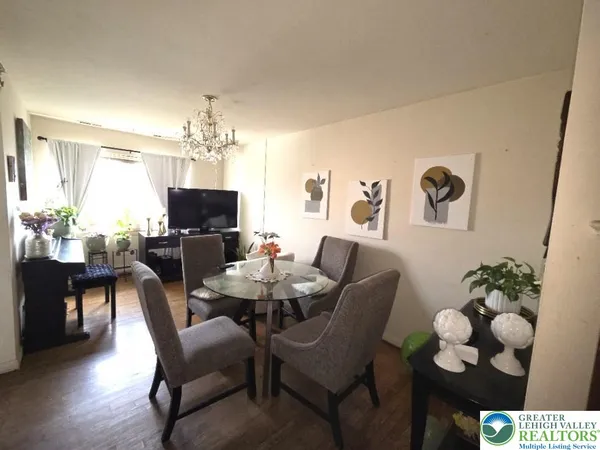 a view of a dining room with furniture and chandelier