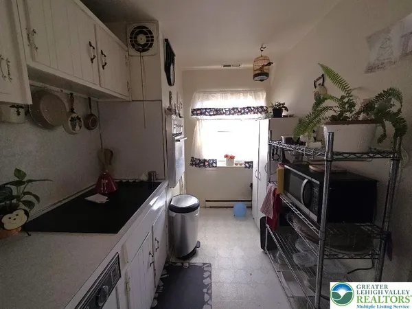 a kitchen with a sink appliances and cabinets