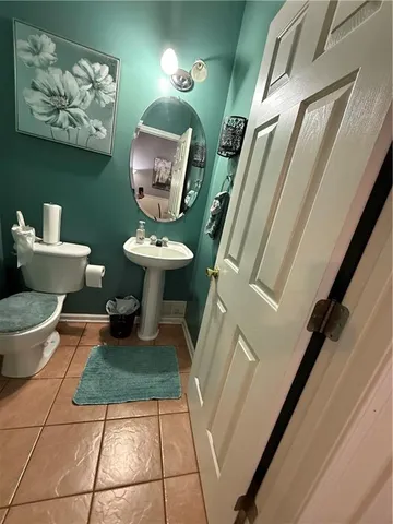a bathroom with a toilet a sink and a mirror
