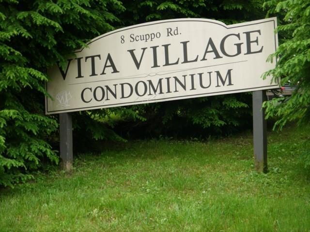 8 Scuppo Road, Unit 8 Danbury, CT 06811 - Photo 1 of 1 a street sign that is on a pole