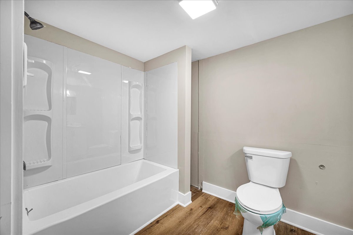 222 West Chestnut Street Hoopeston, IL 60942 - Photo 14 of 28 a white toilet sitting next to a bath tub