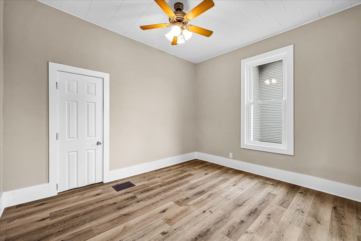 222 West Chestnut Street Hoopeston, IL 60942 - Photo 16 of 28 a view of an empty room with window and wooden floor