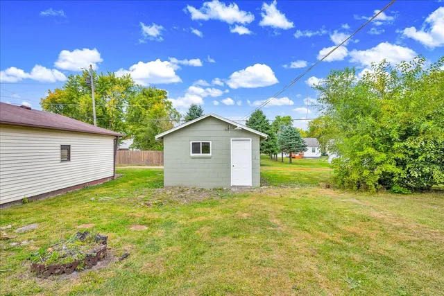 a view of backyard of house with green space