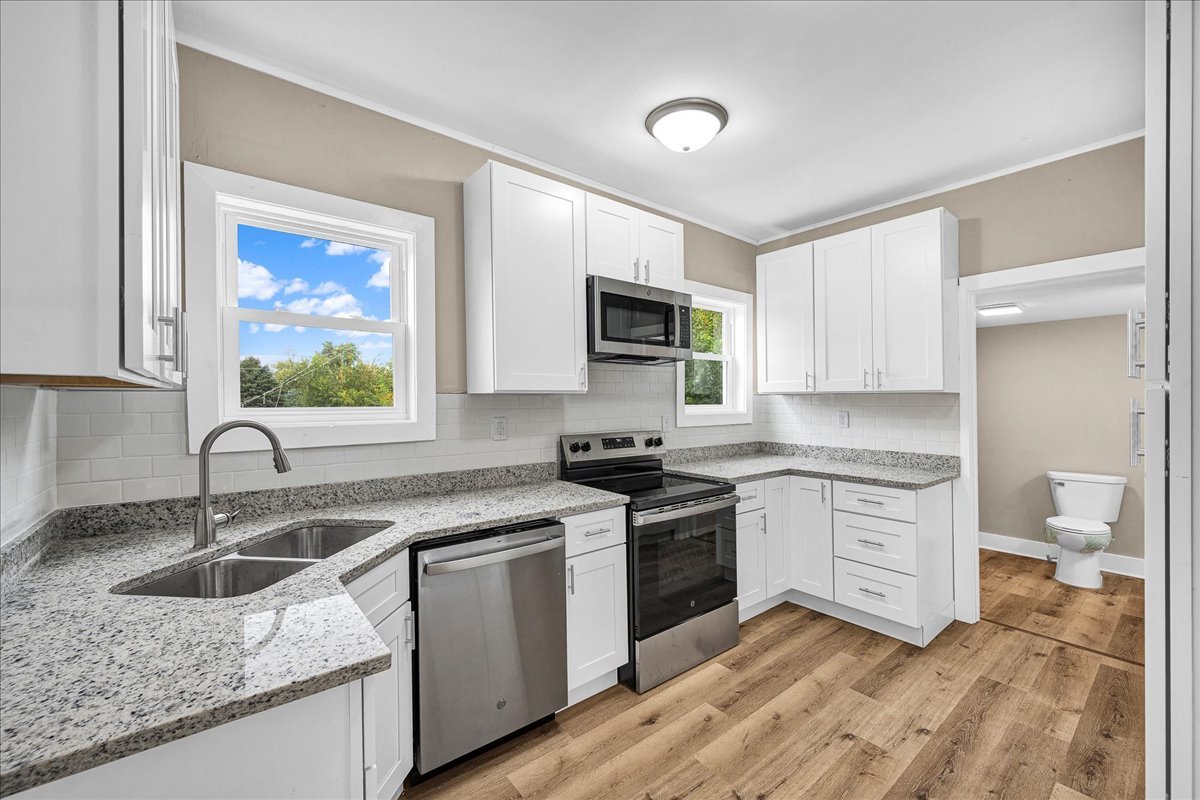 222 West Chestnut Street Hoopeston, IL 60942 - Photo 7 of 28 a kitchen with a sink stove and microwave