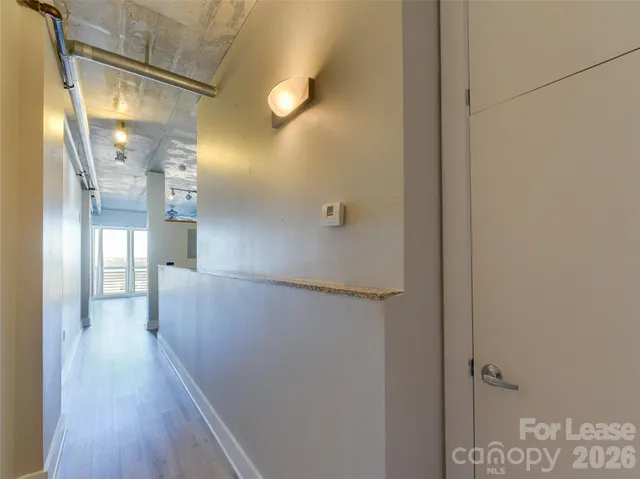 a view of a hallway with wooden floor