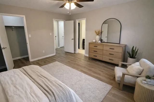 an empty room with wooden floor and window