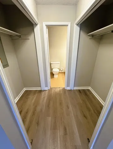 a bathroom with a granite countertop toilet and a sink