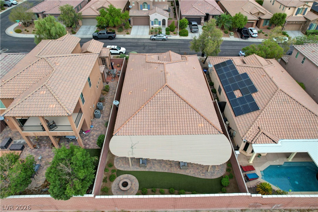 7049 Motley Road Las Vegas, NV 89178 - Photo 61 of 61 An aerial view showcases a tiled roof, patio cover, and enclosed yard in a suburban neighborhood.
