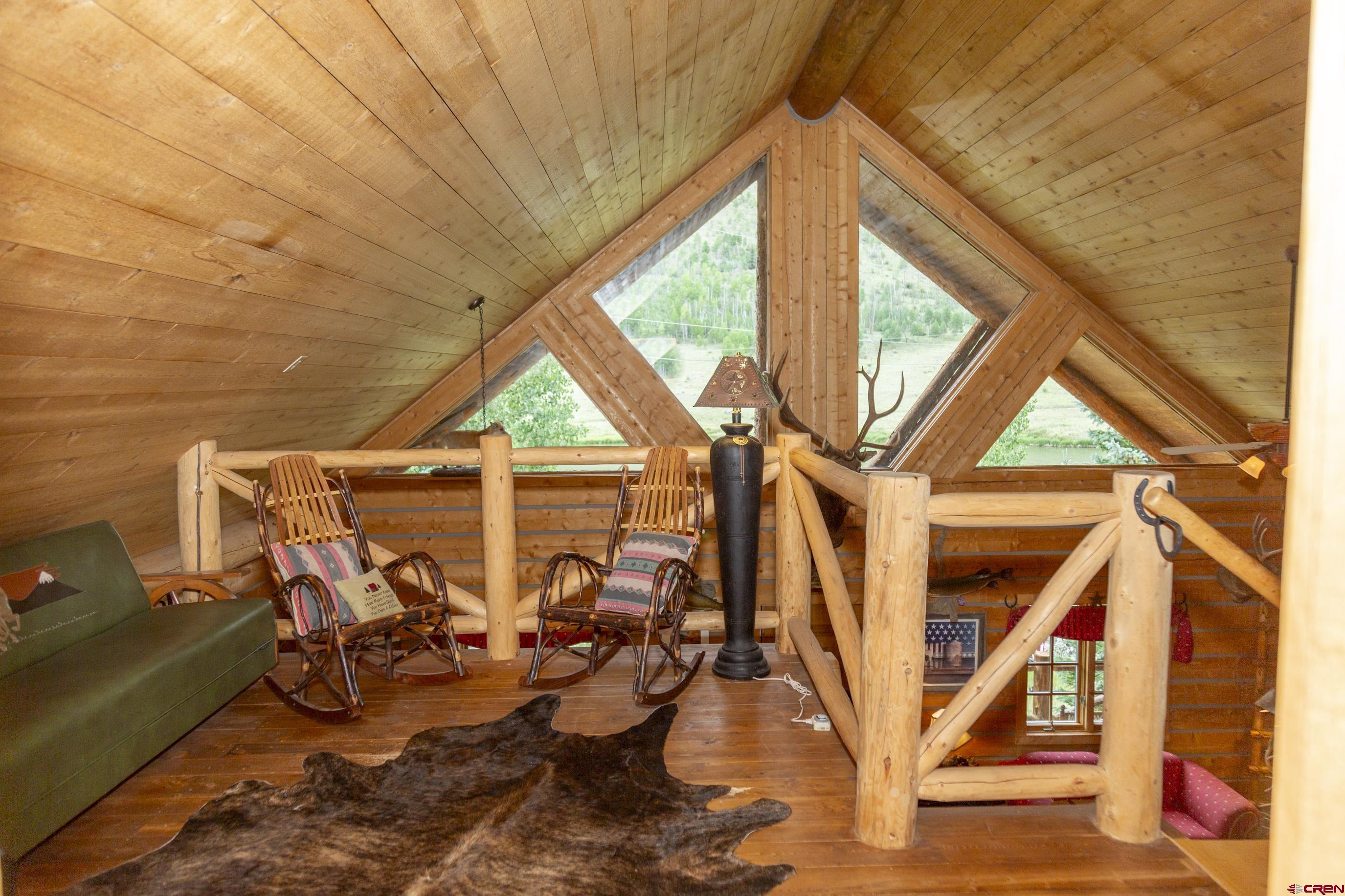 2150 Usfs 521 Road, Unit 18A Creede, CO 81130 - Photo 14 of 31 a view of a room with lots of white furniture and wooden floor