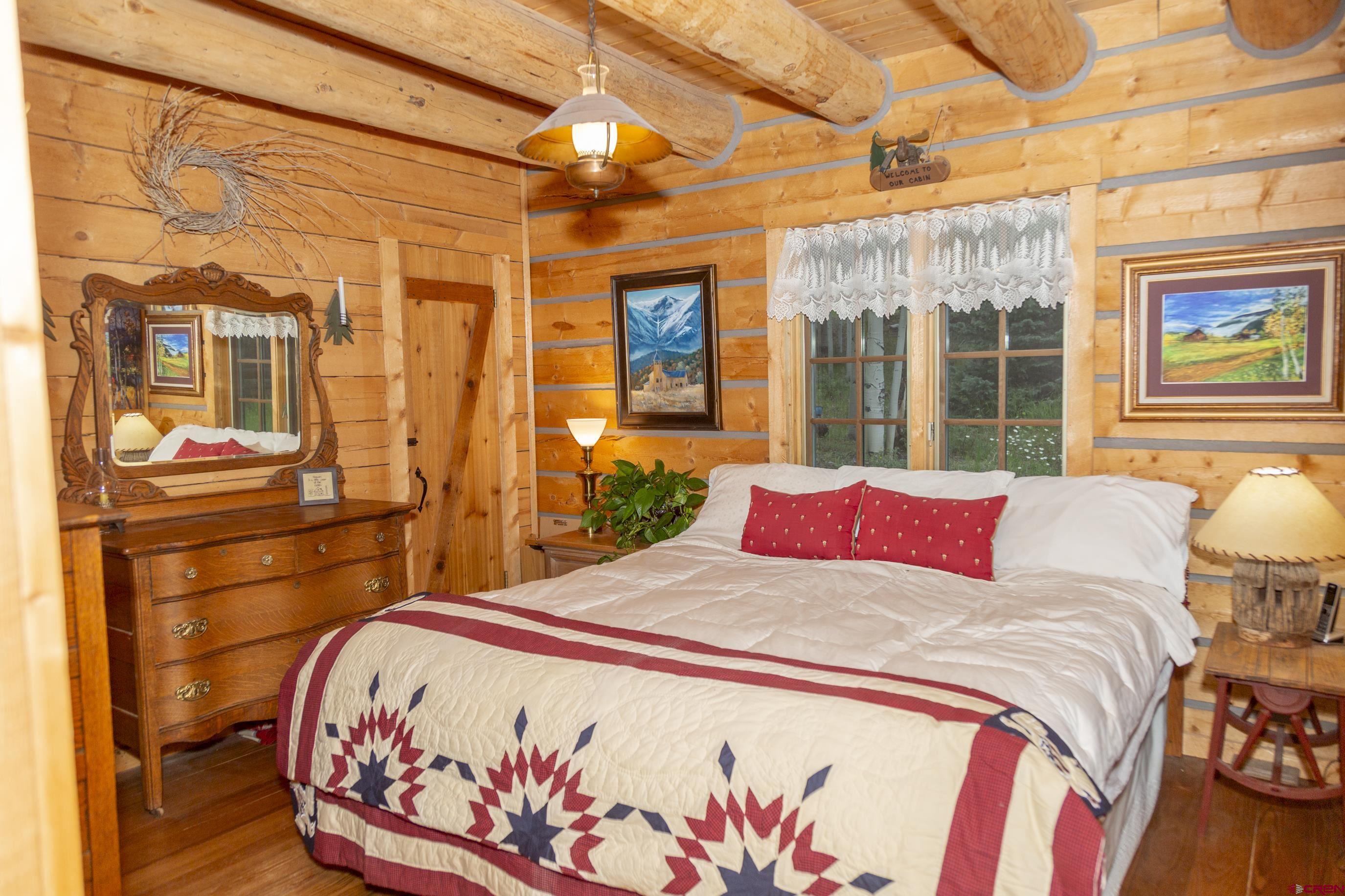 2150 Usfs 521 Road, Unit 18A Creede, CO 81130 - Photo 16 of 31 a bed sitting in a bedroom next to a window