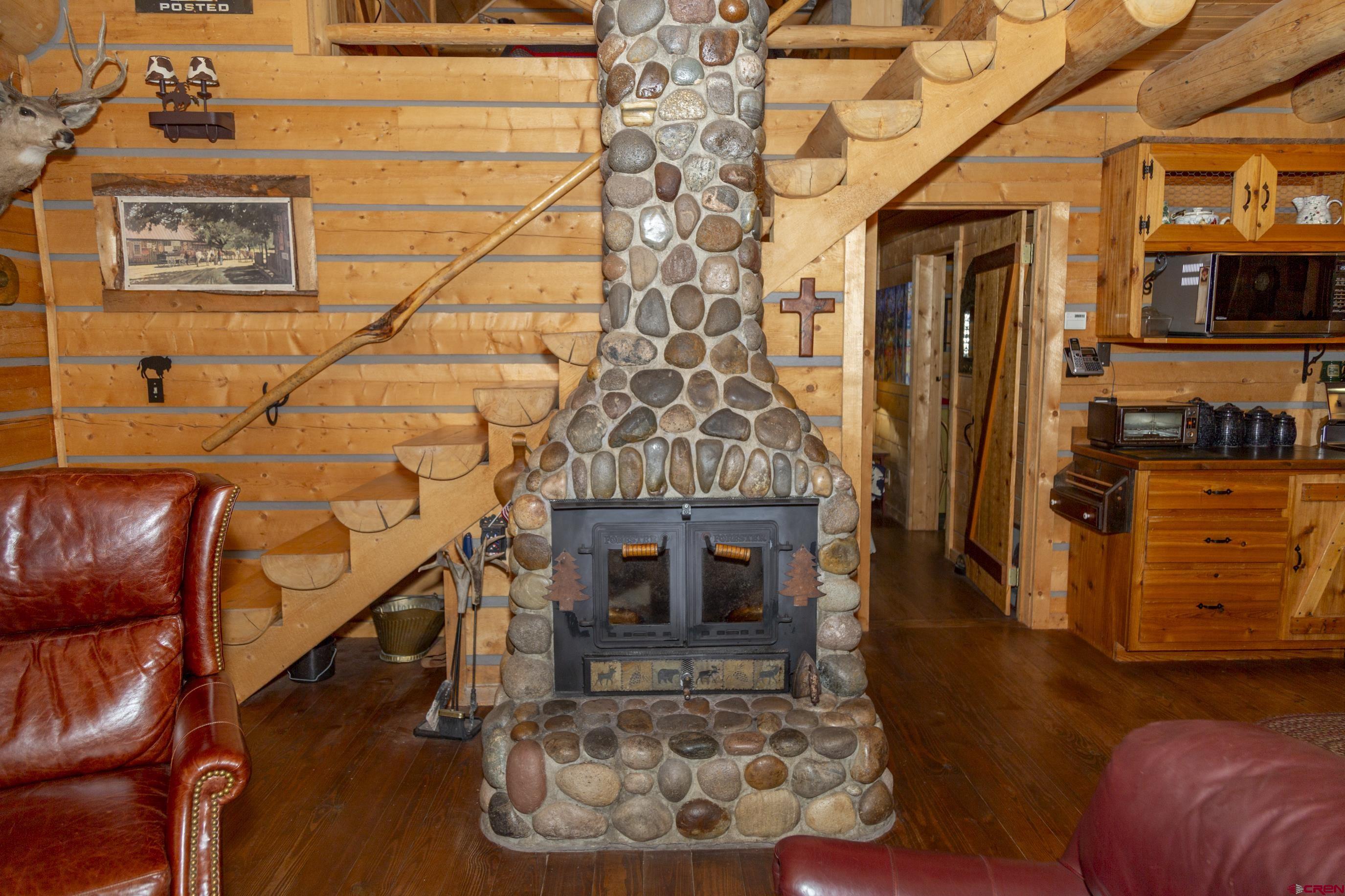 2150 Usfs 521 Road, Unit 18A Creede, CO 81130 - Photo 22 of 31 a living room with furniture and a fireplace