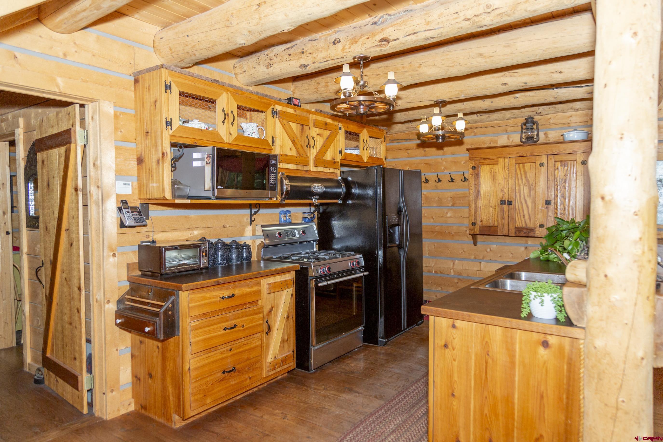 2150 Usfs 521 Road, Unit 18A Creede, CO 81130 - Photo 4 of 31 a kitchen with stainless steel appliances granite countertop a refrigerator and a stove