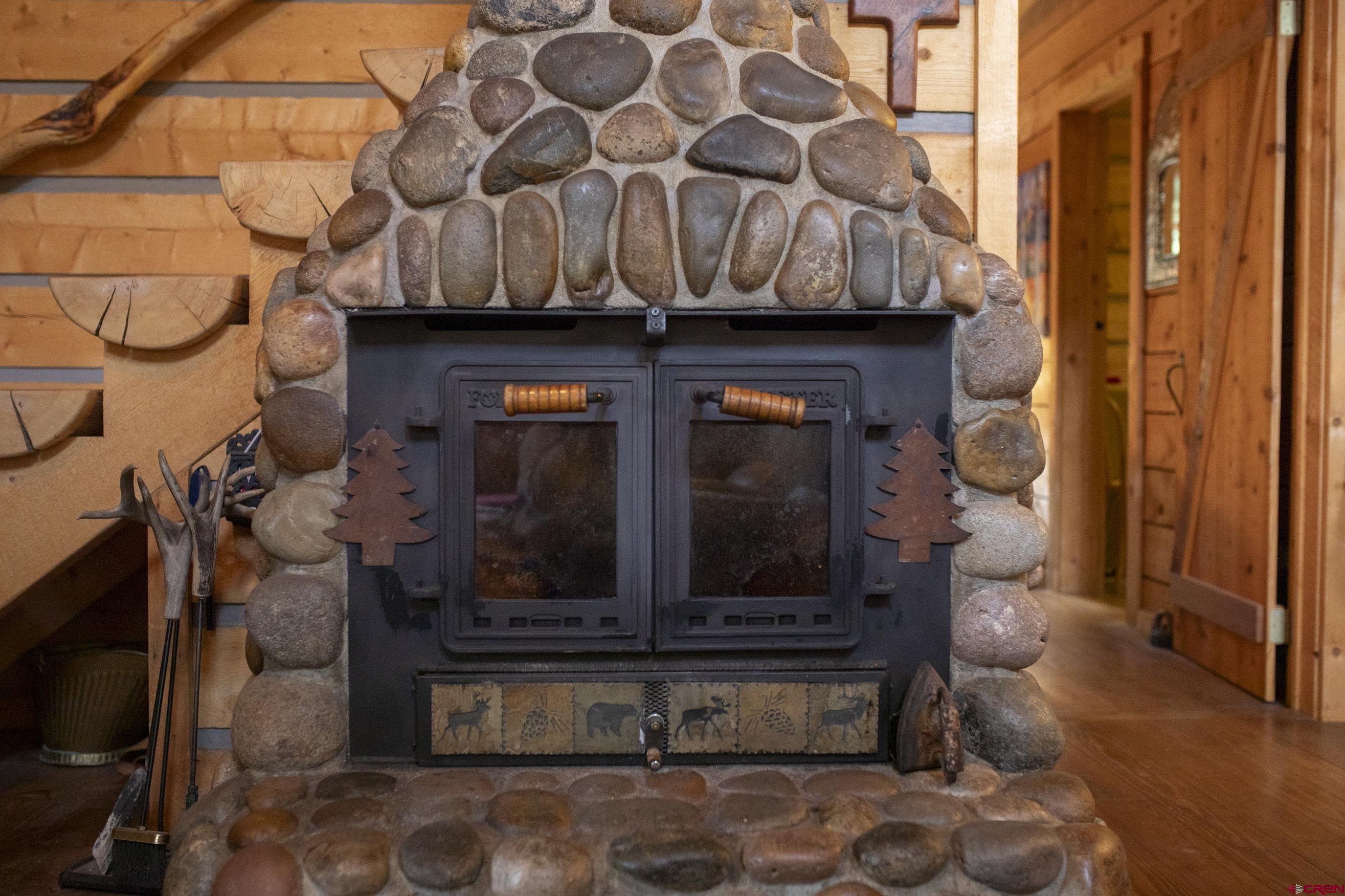 2150 Usfs 521 Road, Unit 18A Creede, CO 81130 - Photo 9 of 31 a living room with furniture and a fireplace