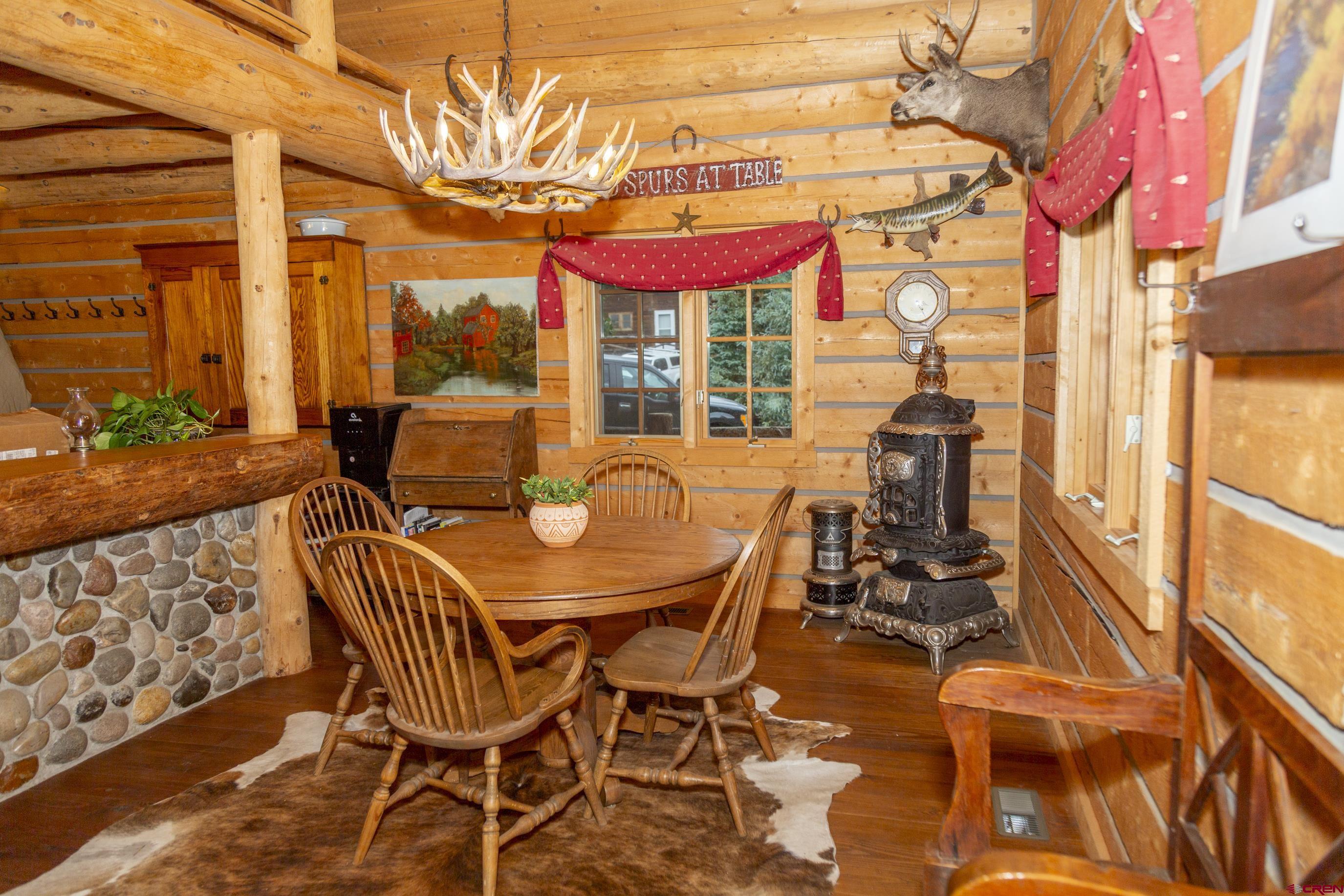 2150 Usfs 521 Road, Unit 18A Creede, CO 81130 - Photo 10 of 31 a dining room with furniture and a floor to ceiling window