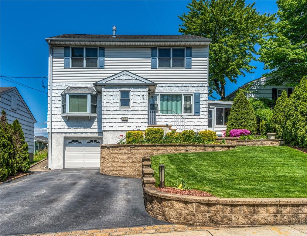 405 Fenimore Road Mamaroneck, NY 10543 - Photo 1 of 1 a front view of a house with a yard and garage