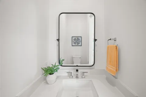 a bathroom with a sink vanity and a mirror