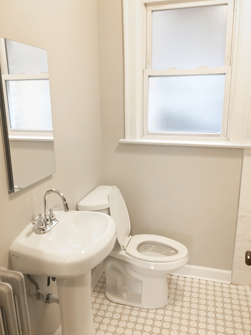1941 Grove Avenue, Unit 201 Berwyn, IL 60402 - Photo 13 of 13 a bathroom with a sink a toilet and mirror