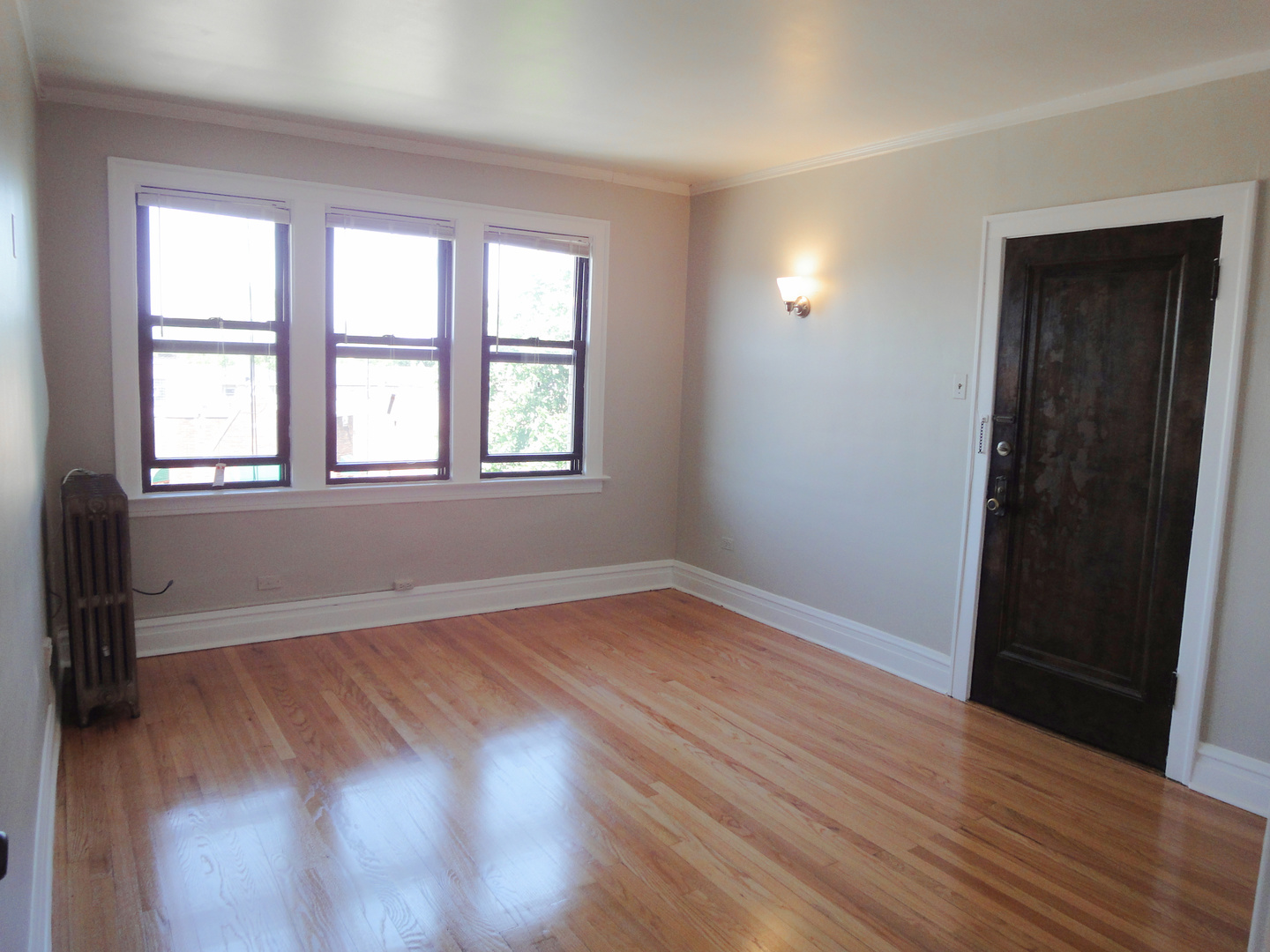 1941 Grove Avenue, Unit 201 Berwyn, IL 60402 - Photo 2 of 13 an empty room with wooden floor and windows