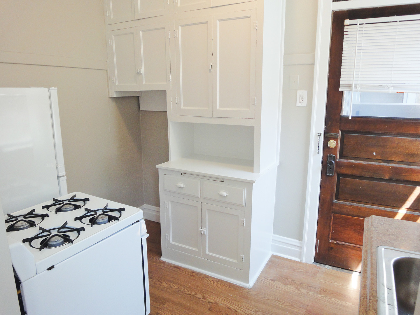 1941 Grove Avenue, Unit 201 Berwyn, IL 60402 - Photo 3 of 13 a kitchen with a stove and a refrigerator