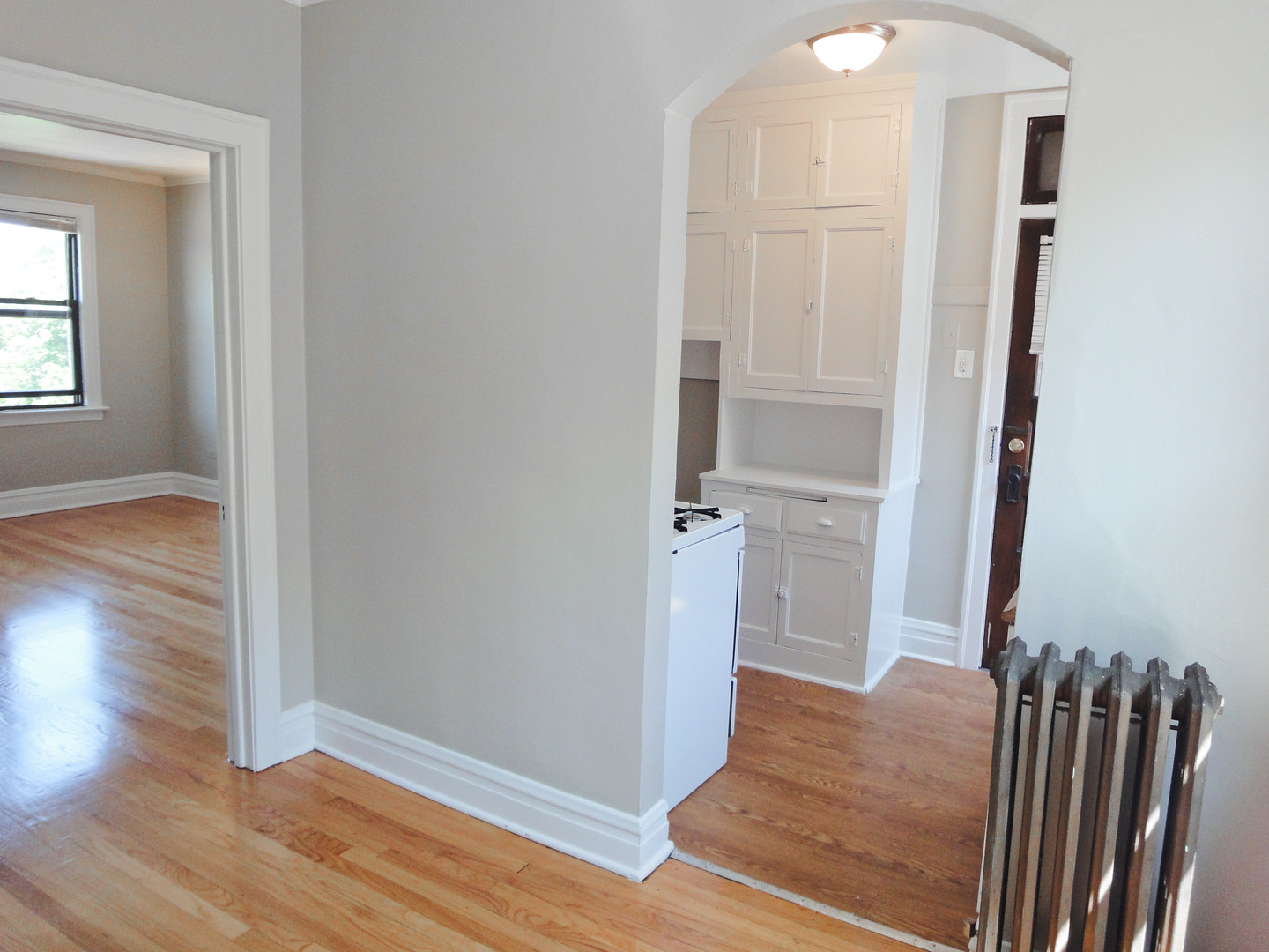 1941 Grove Avenue, Unit 201 Berwyn, IL 60402 - Photo 8 of 13 an empty room with wooden floor door and windows