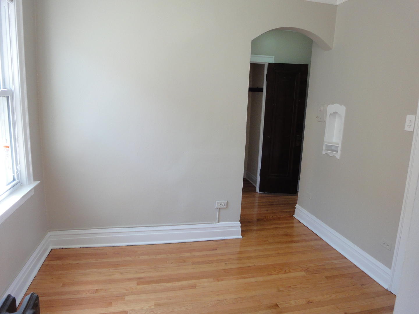 1941 Grove Avenue, Unit 201 Berwyn, IL 60402 - Photo 9 of 13 a view of an empty room with wooden floor and a window