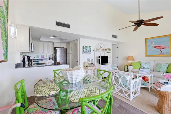 a living room with dining table and a table
