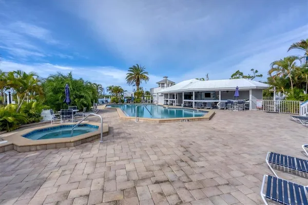 a view of a swimming pool and lounge chairs