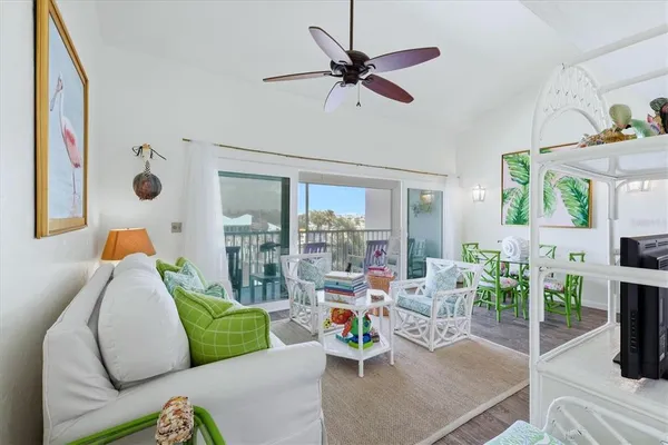a living room with furniture and a floor to ceiling window