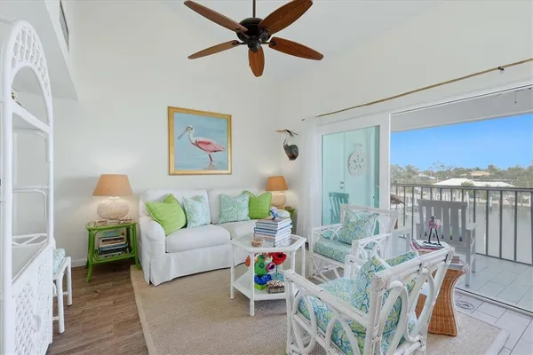 a living room with furniture a rug and a chandelier