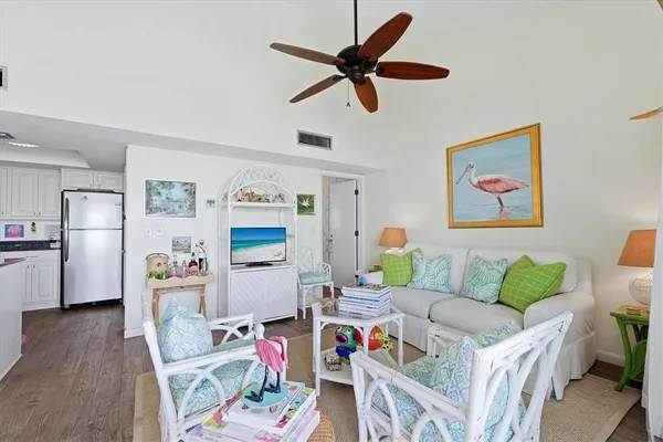 a living room with furniture and kitchen view