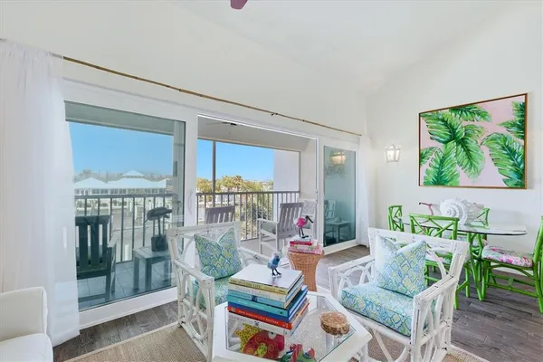 a living room with furniture and a floor to ceiling window
