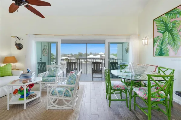 a living room with furniture and a floor to ceiling window