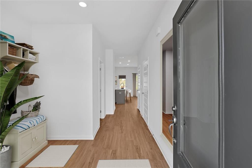 103 Lavender Circle Calhoun, GA 30701 - Photo 4 of 19 a view of a hallway with wooden floor and a bathroom