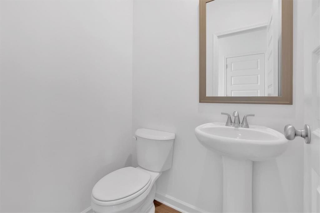 103 Lavender Circle Calhoun, GA 30701 - Photo 9 of 19 a white toilet sitting next to a bathroom sink