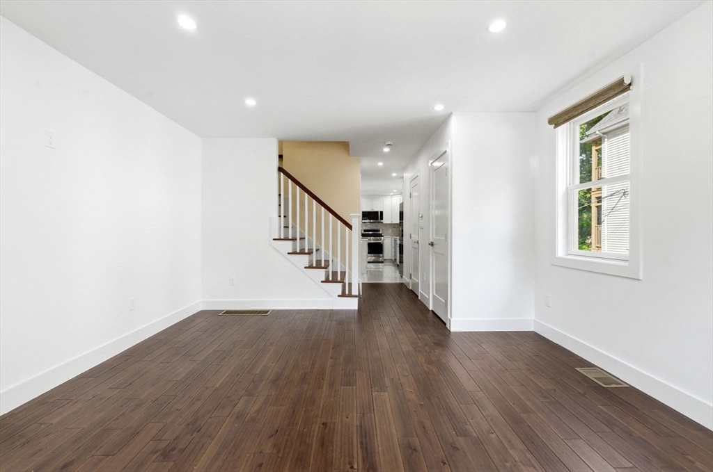 123 Nottinghill Road, Unit 2 Boston, MA 02135 - Photo 3 of 30 a view of an empty room with wooden floor and a window