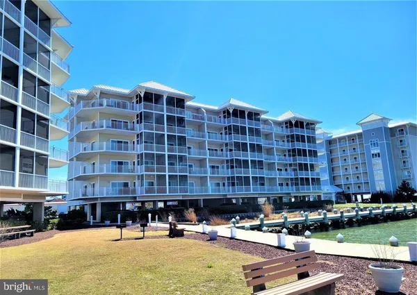 a building view with swimming pool and outdoor seating