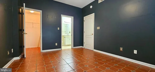 an empty room with windows and closet