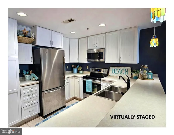a kitchen with stainless steel appliances kitchen island granite countertop a refrigerator sink and stove