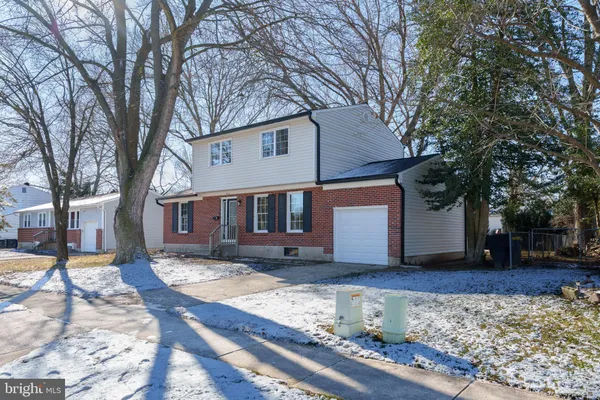 a wooden bench sitting in front of a house