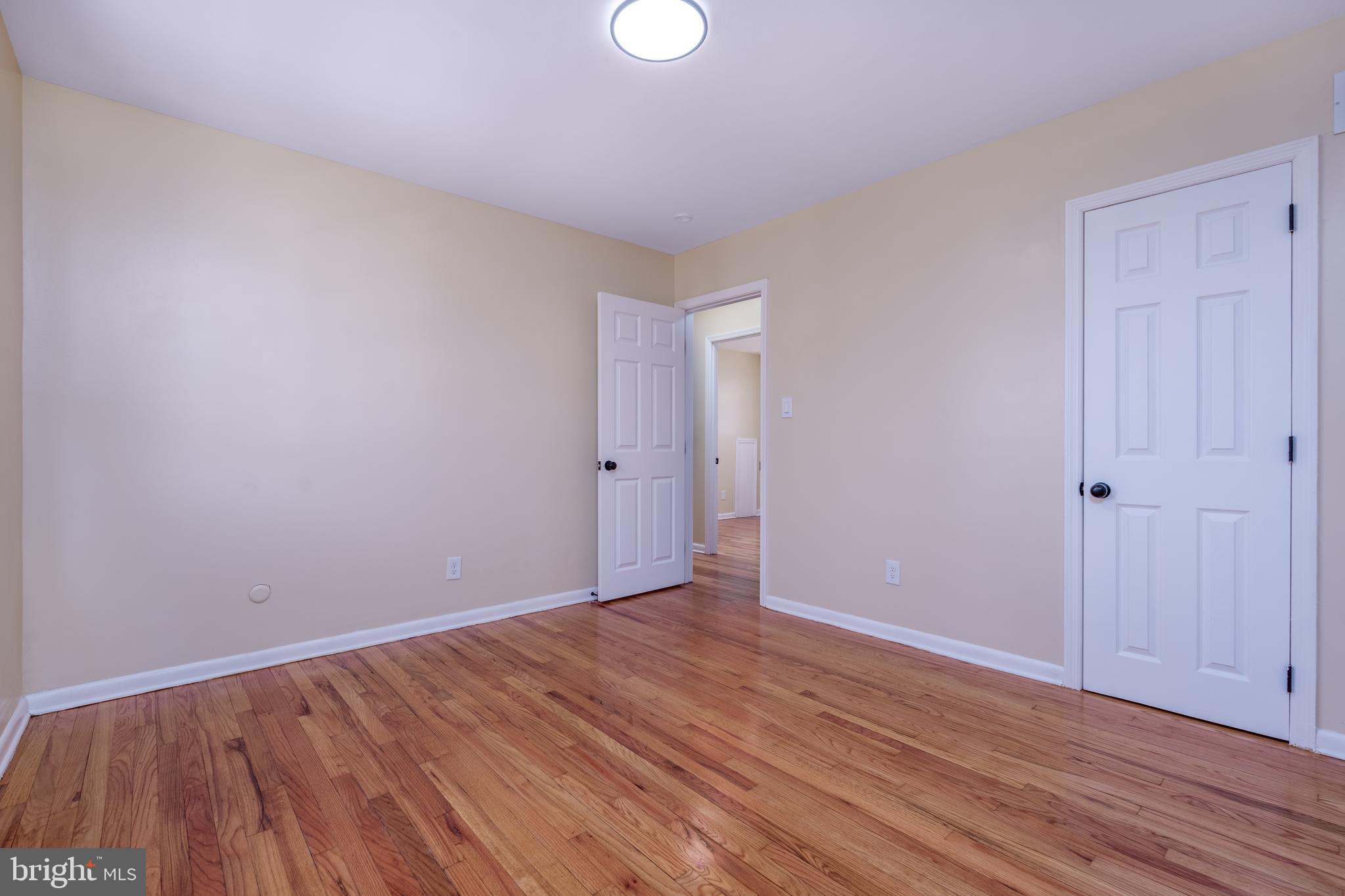 344 Nimitz Road Dover, DE 19901 - Photo 18 of 26 a view of an empty room with wooden floor and windows