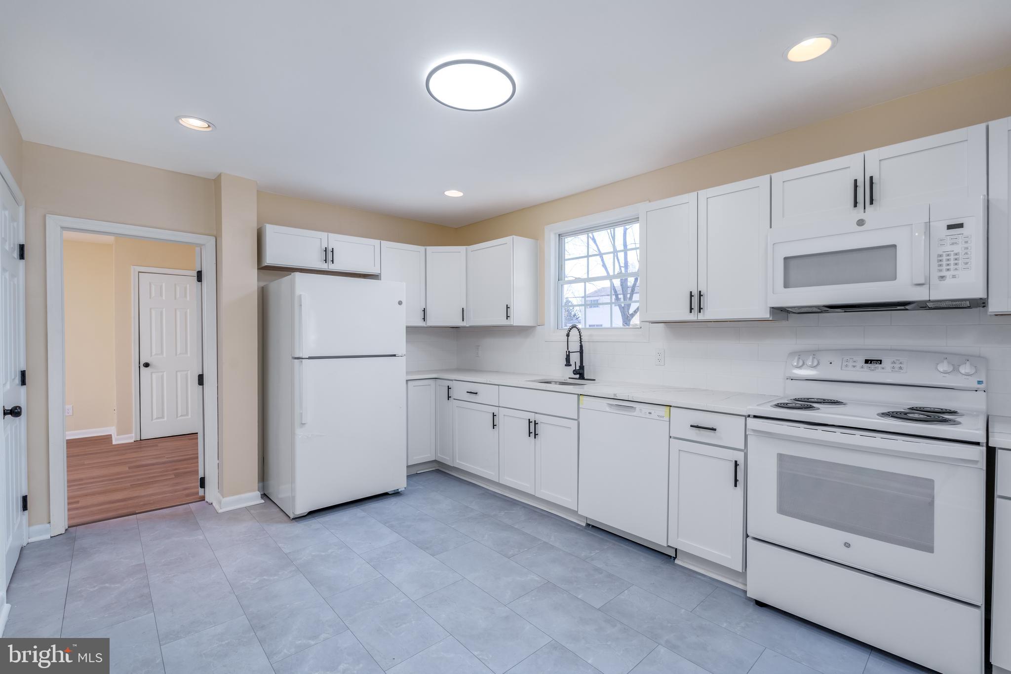 344 Nimitz Road Dover, DE 19901 - Photo 6 of 26 a kitchen with cabinets appliances and a window
