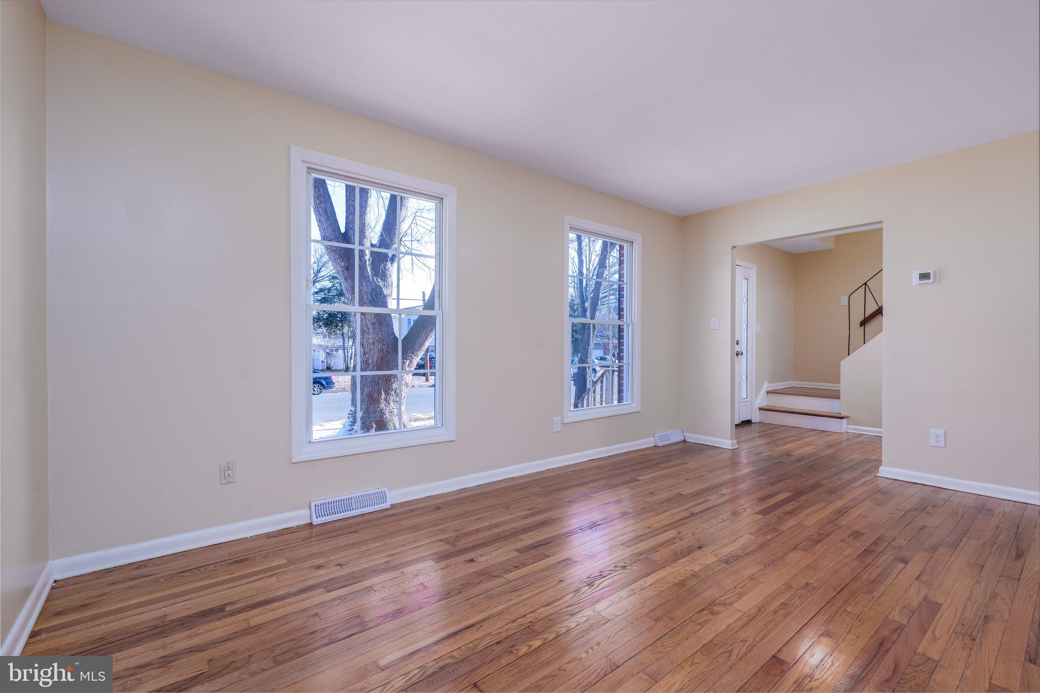 344 Nimitz Road Dover, DE 19901 - Photo 8 of 26 a view of an empty room with wooden floor and a window