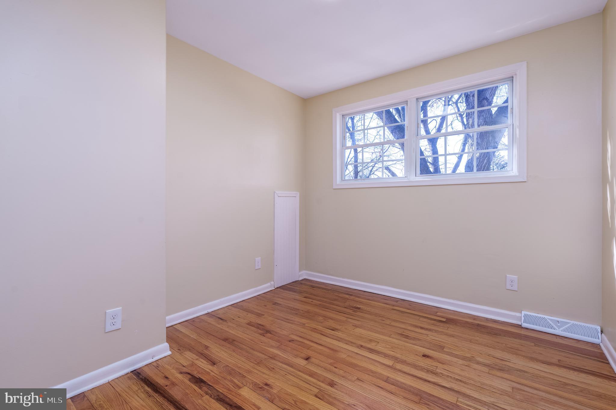 344 Nimitz Road Dover, DE 19901 - Photo 10 of 26 an empty room with wooden floor and windows